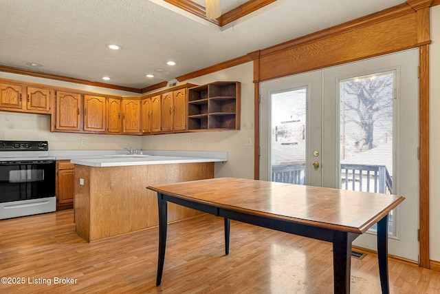 kitchen with range with electric cooktop, light countertops, ornamental molding, french doors, and light wood-type flooring