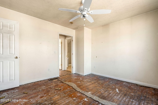 spare room with wood-type flooring, a textured ceiling, baseboards, and a ceiling fan