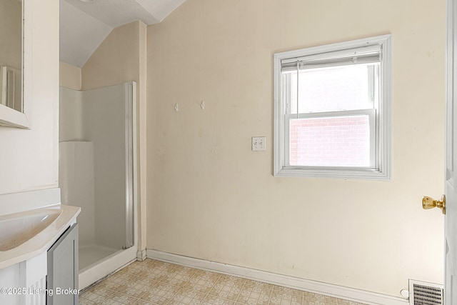 bathroom with visible vents, vaulted ceiling, a shower stall, baseboards, and tile patterned floors