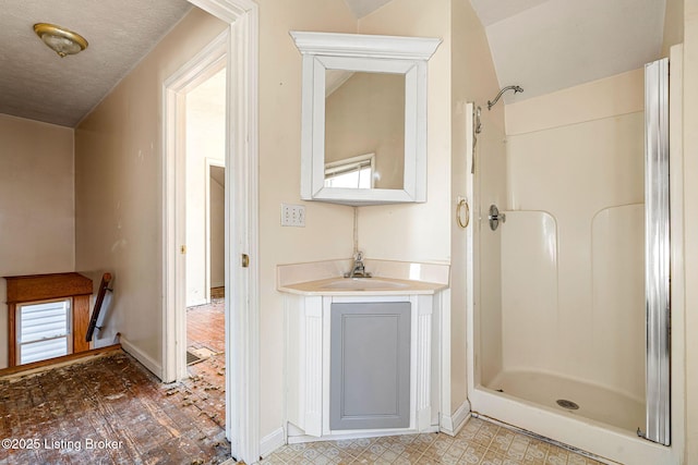 bathroom with tile patterned floors, a shower stall, baseboards, and vanity