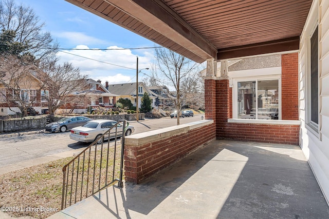 view of patio / terrace featuring a porch and a residential view