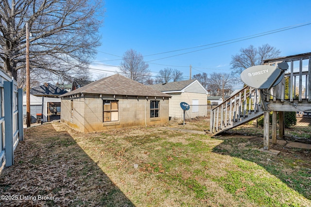 view of yard featuring stairway and fence