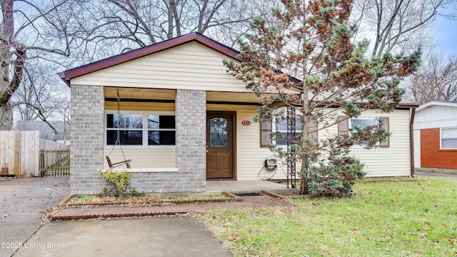 bungalow-style house featuring a front yard and fence