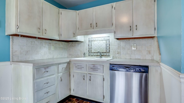 kitchen with tasteful backsplash, light countertops, a sink, and stainless steel dishwasher