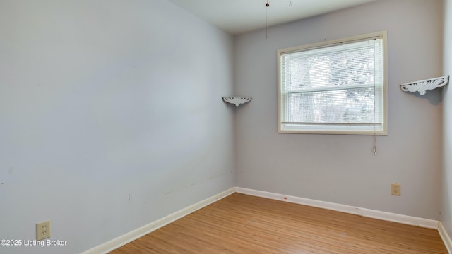 empty room with light wood-style floors and baseboards