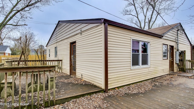 view of home's exterior with fence and a deck