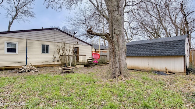 view of yard with a storage unit, fence, and an outdoor structure