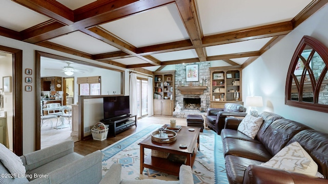 living room with a fireplace, coffered ceiling, beam ceiling, and wood finished floors