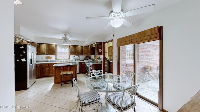 dining space featuring light tile patterned floors and a ceiling fan