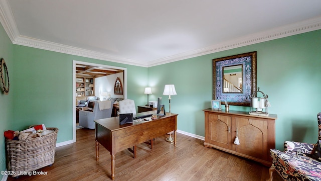 office space featuring ornamental molding, wood finished floors, and baseboards