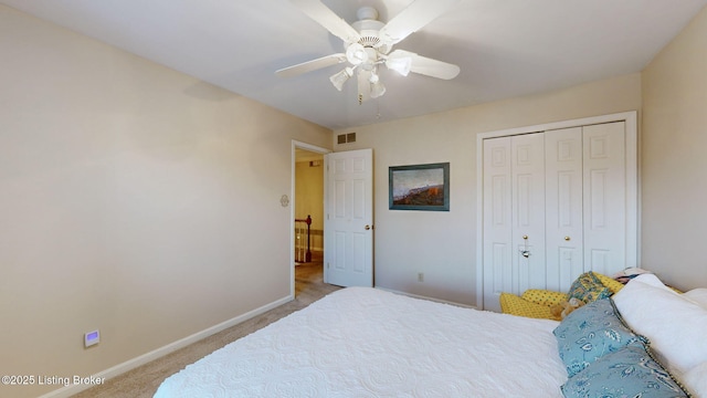 carpeted bedroom featuring a ceiling fan, baseboards, visible vents, and a closet