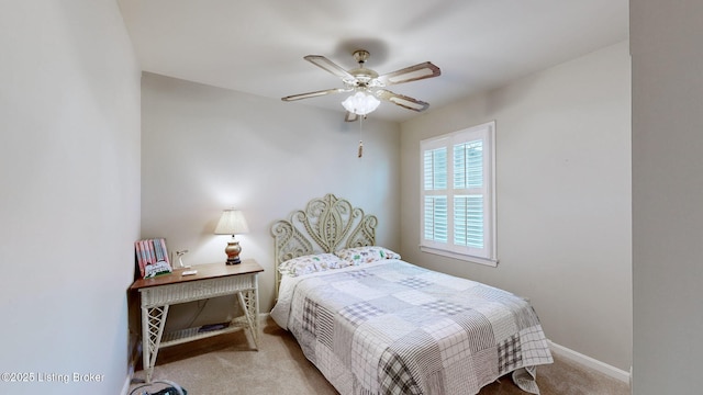 carpeted bedroom featuring a ceiling fan and baseboards