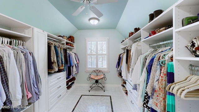 spacious closet featuring a ceiling fan, lofted ceiling, and light tile patterned floors