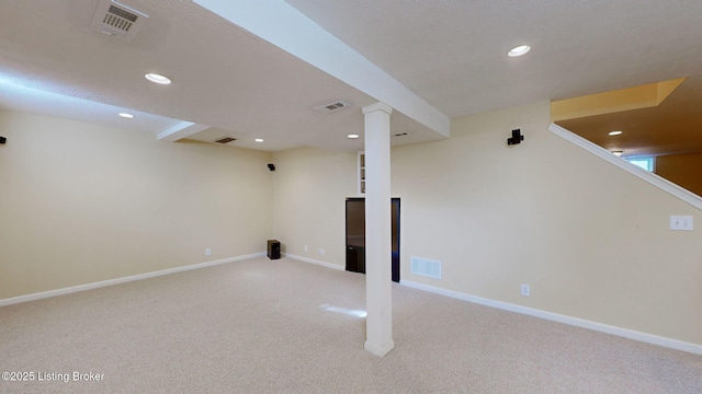 finished basement featuring light carpet, baseboards, visible vents, and recessed lighting