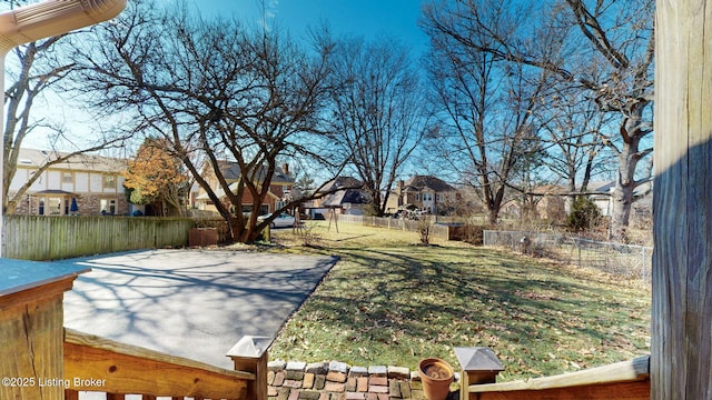 view of yard featuring a fenced backyard and a residential view