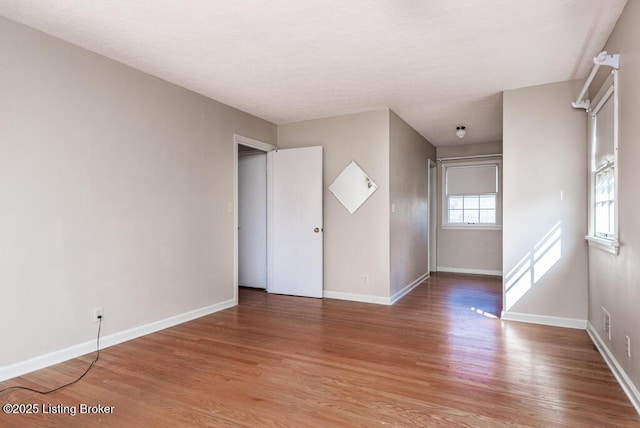 spare room with light wood-type flooring and baseboards