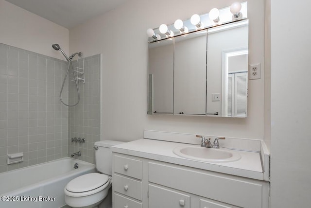 bathroom featuring toilet, tub / shower combination, and vanity