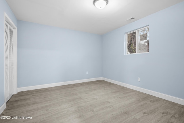 unfurnished bedroom with a closet, light wood-type flooring, and baseboards