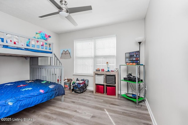 bedroom with wood finished floors, baseboards, and ceiling fan