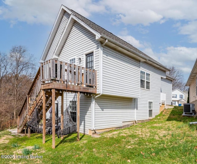 view of property exterior featuring a wooden deck, stairway, central AC unit, and a lawn