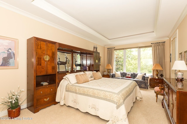 bedroom with light colored carpet, a tray ceiling, and ornamental molding