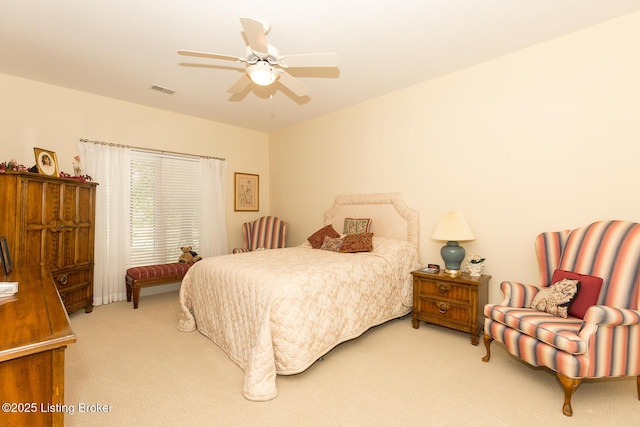 carpeted bedroom with visible vents and ceiling fan