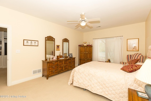 bedroom with a ceiling fan, baseboards, visible vents, and light carpet