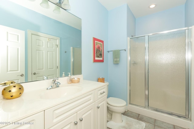 bathroom featuring vanity, toilet, and a stall shower