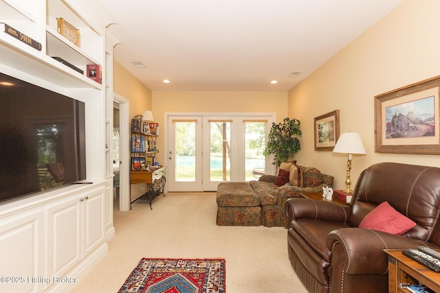 living room with recessed lighting, visible vents, and light colored carpet