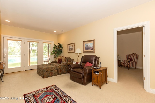 living room with recessed lighting, baseboards, and light carpet