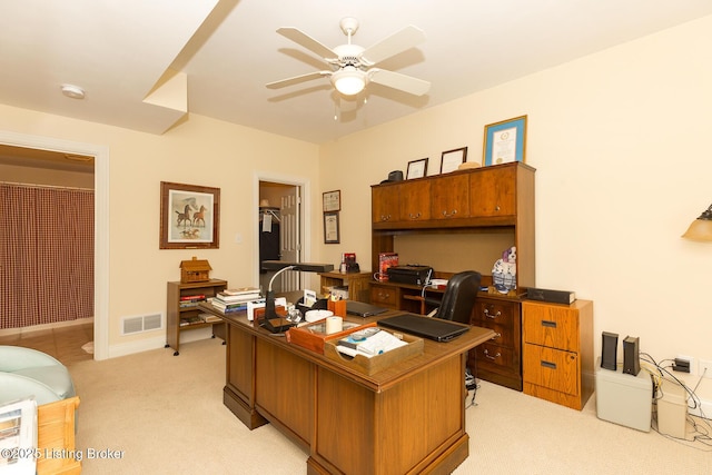 office featuring light carpet, visible vents, baseboards, and ceiling fan