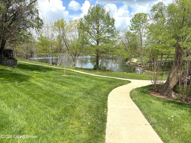 surrounding community with a yard and a water view