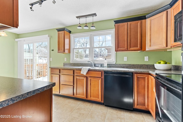 kitchen featuring a textured ceiling, black appliances, dark countertops, and brown cabinets