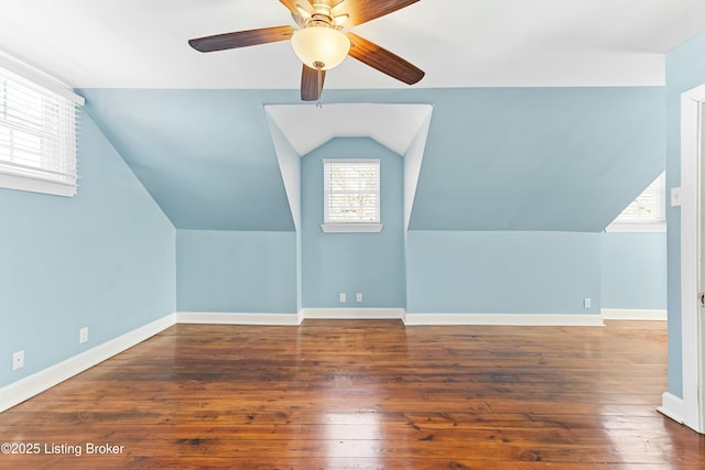 additional living space with ceiling fan, baseboards, vaulted ceiling, and dark wood-type flooring