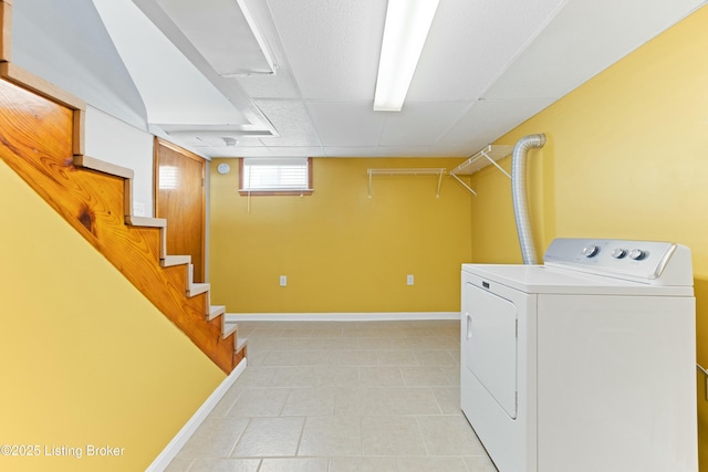 laundry area with laundry area, washer / clothes dryer, and baseboards