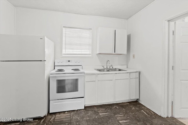 kitchen featuring white appliances, white cabinets, light countertops, a textured ceiling, and a sink