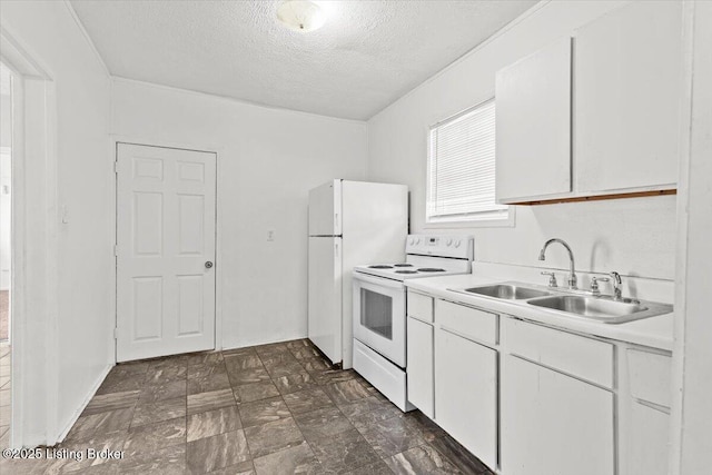 kitchen with light countertops, white appliances, a sink, and white cabinetry