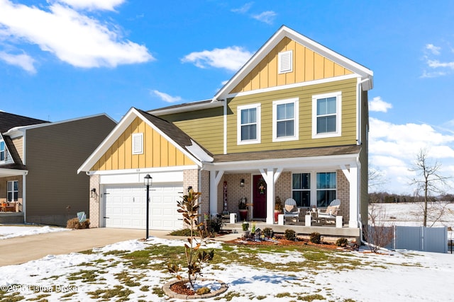 view of front of house featuring board and batten siding, brick siding, and a garage