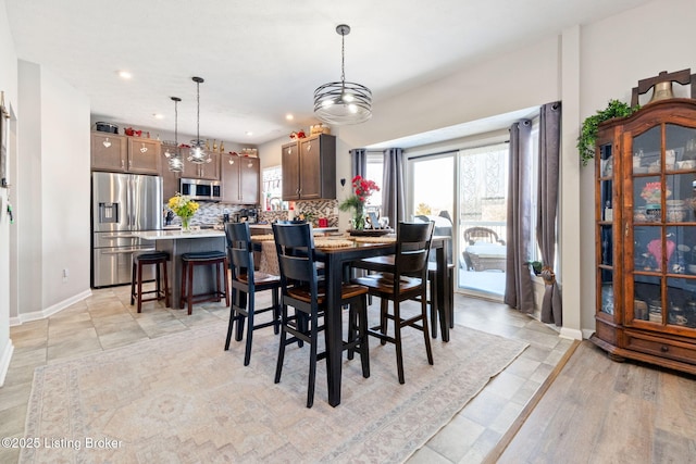 dining room featuring recessed lighting and baseboards