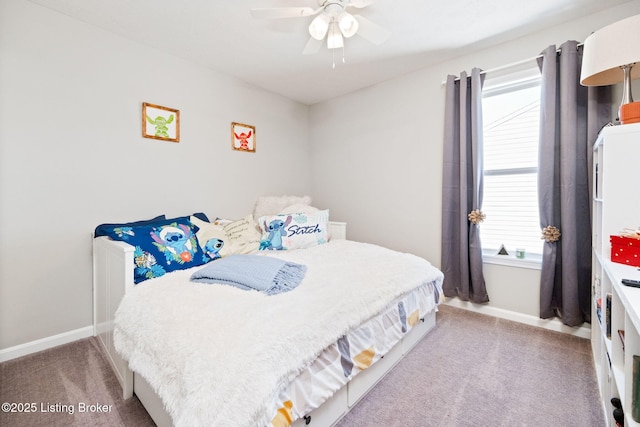 bedroom with a ceiling fan, carpet flooring, and baseboards