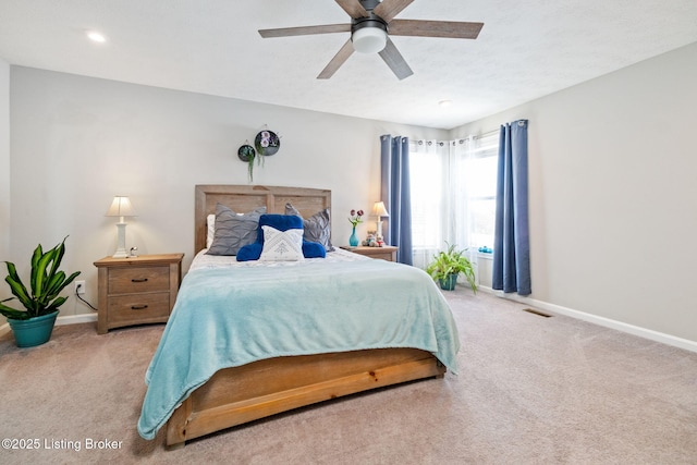 bedroom featuring carpet floors, baseboards, visible vents, and ceiling fan