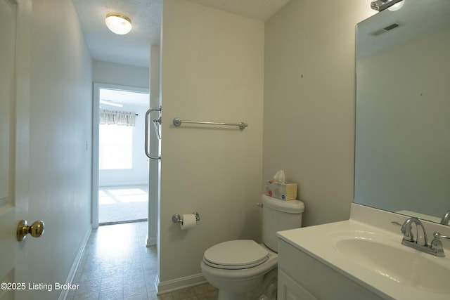 half bath with baseboards, visible vents, toilet, a textured ceiling, and vanity