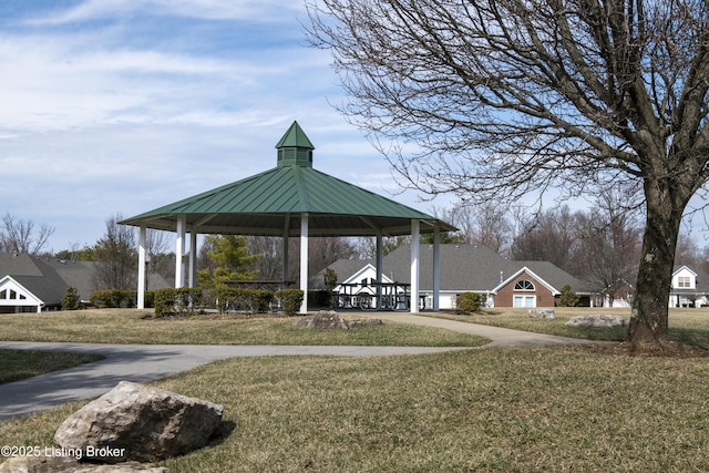 view of community with a gazebo, a lawn, and driveway