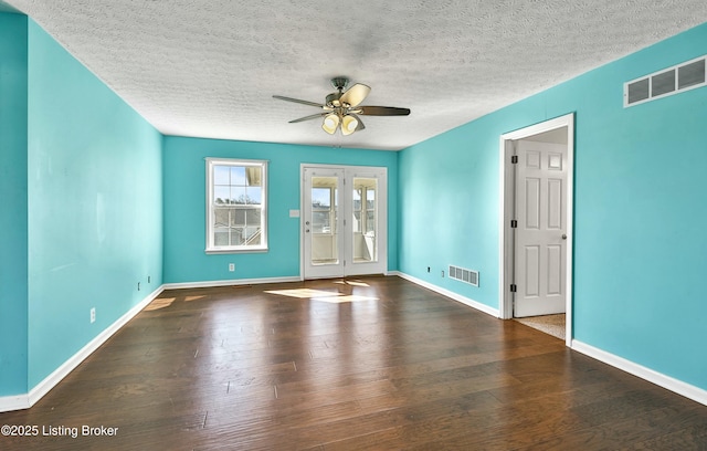 spare room featuring visible vents, ceiling fan, and wood finished floors