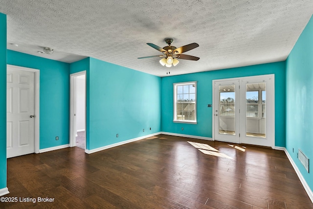 interior space featuring a ceiling fan, baseboards, visible vents, and wood finished floors