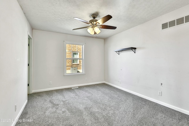 unfurnished room featuring a textured ceiling, ceiling fan, carpet floors, visible vents, and baseboards