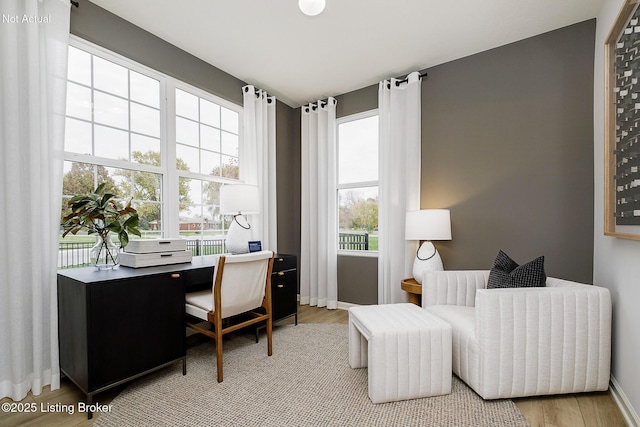 home office featuring light wood-type flooring and baseboards