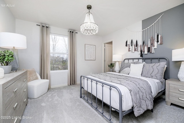 bedroom with baseboards, a chandelier, and light colored carpet