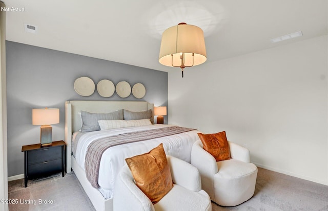 carpeted bedroom featuring baseboards and visible vents