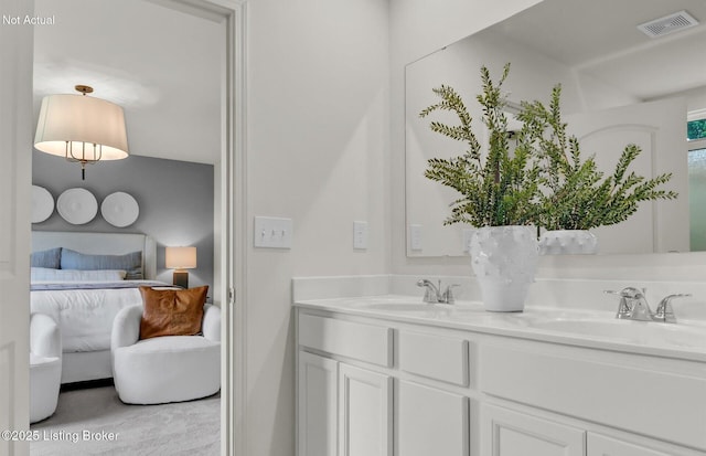 full bath featuring a sink, double vanity, ensuite bath, and visible vents